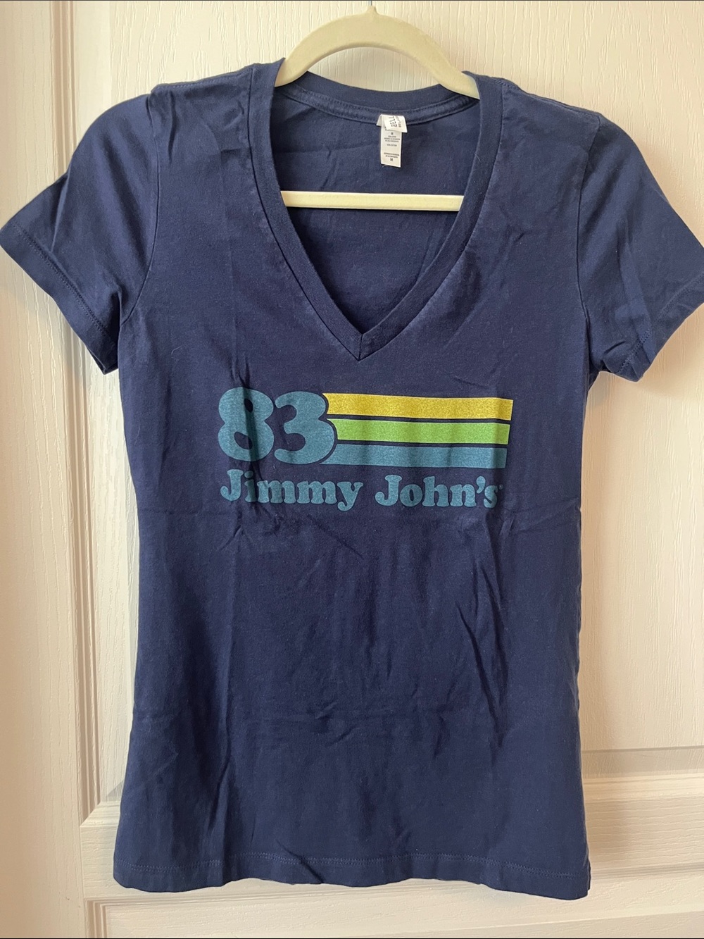 Jimmy John’s Bella Canvas Navy V-Neck Tee with Blue and Yellow Retro Stripe